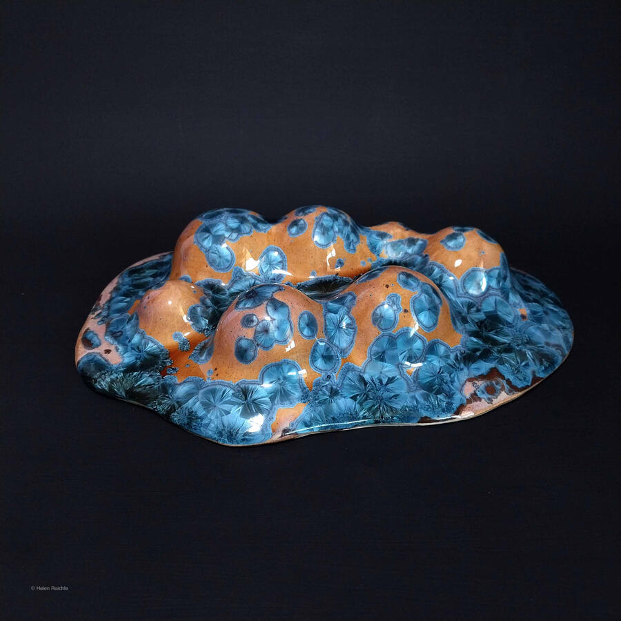 Botryoidal, globular, mammillary shape resembles natural minerals. Chatoyant, blue crystal glaze with orange-yellow background